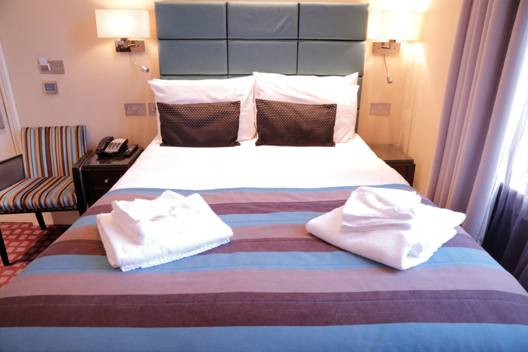 A standard double bedroom at Astors Belgravia Hotel